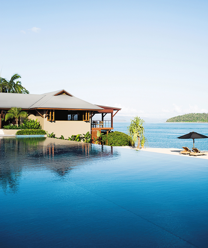 qualia resort Pebble Beach infinity pool with restaurant overlooking beach and Whitsundays views