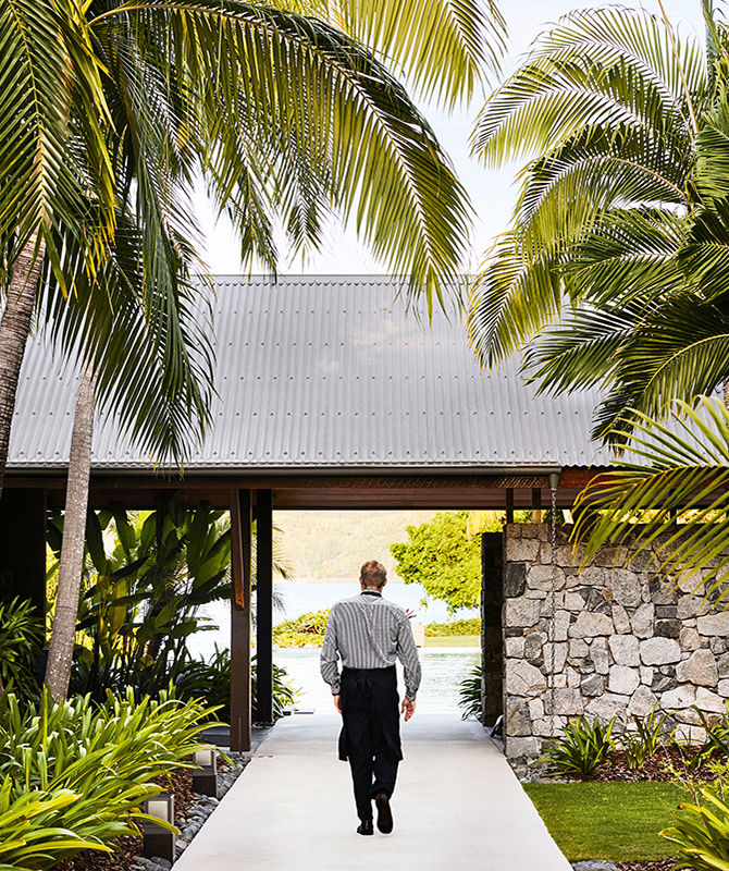 qualia resort Pebble Beach restaurant waiter walking through garden path in the Whitsundays