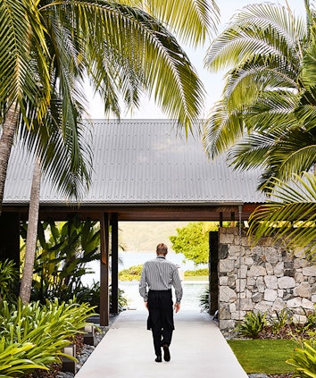 qualia resort Pebble Beach restaurant waiter walking through garden path in the Whitsundays