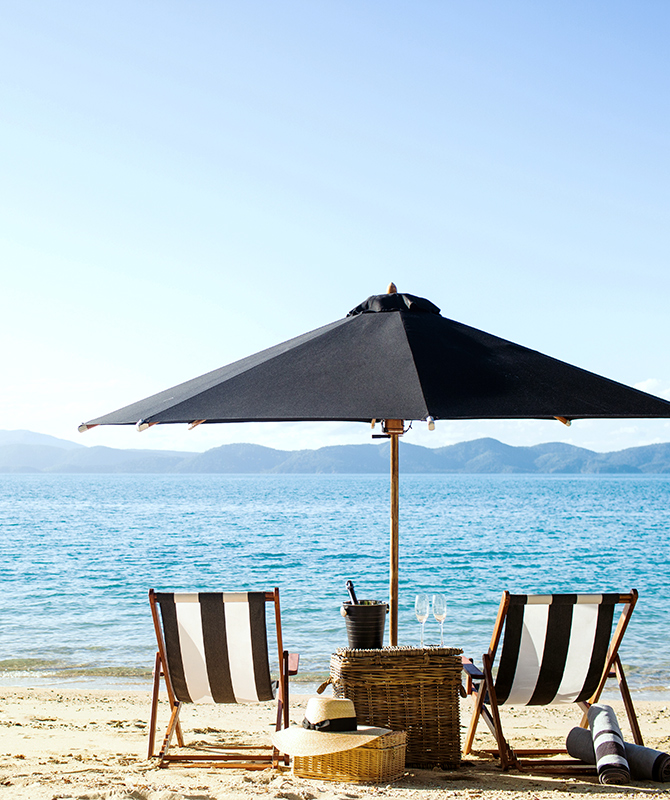 qualia Resort Luxury Beach Drop Off Experience with Two Sun Chairs and Umbrella on the Beach