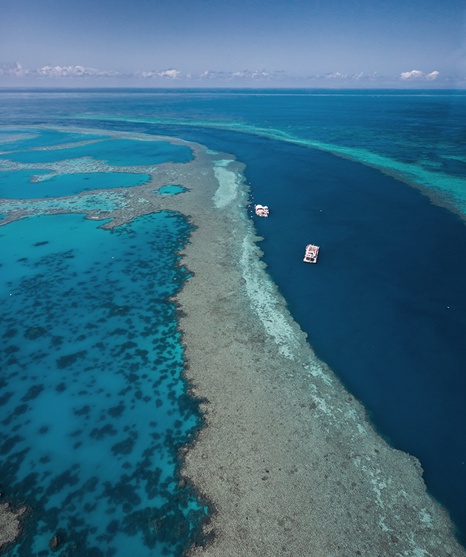 Aerial view from qualia scenic flight experience of boat and pontoon in Great Barrier Reef
