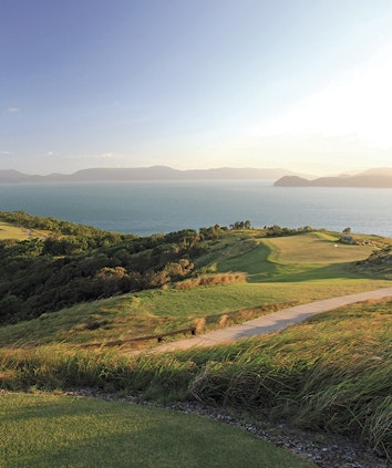 qualia View across Hamilton Island Golf Course with sunlight pouring across from neighboring Whitsunday island