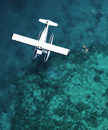 Aerial of luxury sea plane landed on Great Barrier Reef waters as part of qualia scenic flight experience