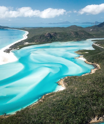 Aerial of swirling sand banks and turquoise water at Whitehaven Beach near qualia resort
