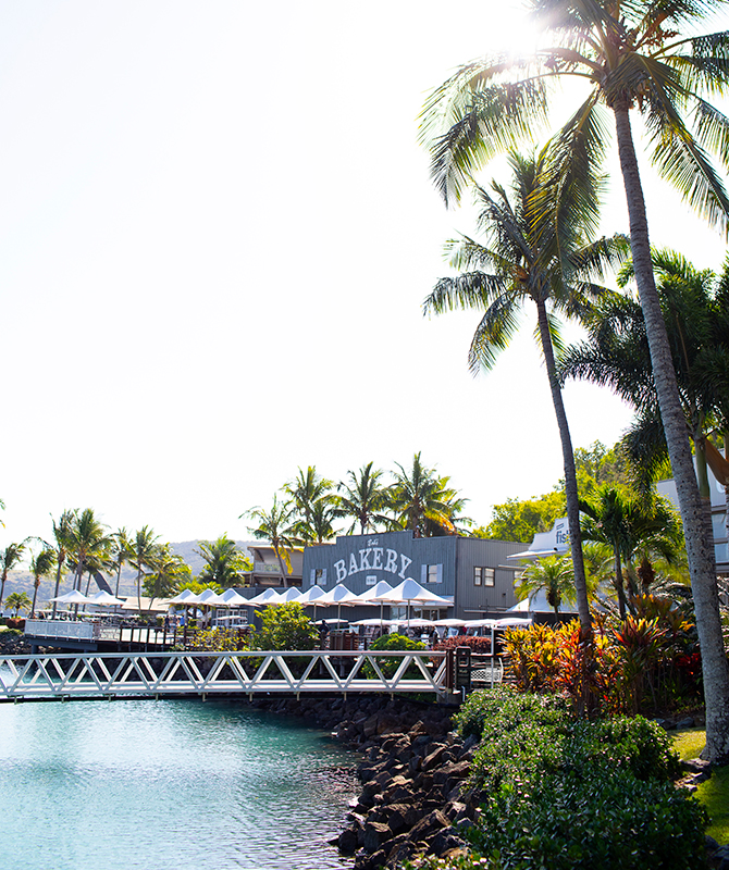 Walkway to Hamilton Island Marina with Bakery building and garden