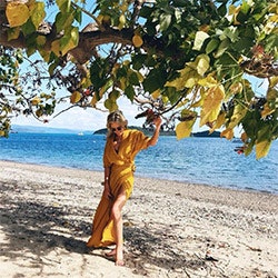 Lady in orange dress on Pebble Beach, qualia