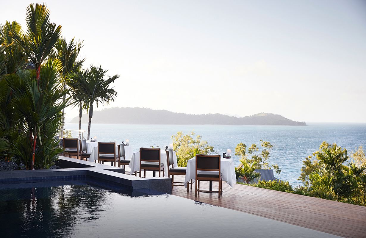 qualia waiter carrying tray of champagne glasses at Long Pavilion restaurant