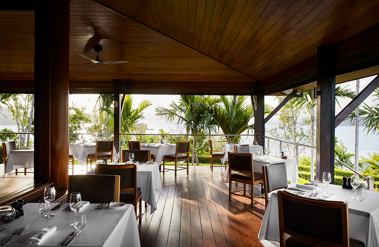 Whitsunday sunset view from dinner tables set outdoor at qualia resort's Long Pavilion restaurant