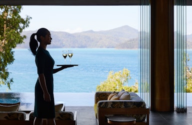 qualia waiter carrying tray of champagne glasses at Long Pavilion restaurant