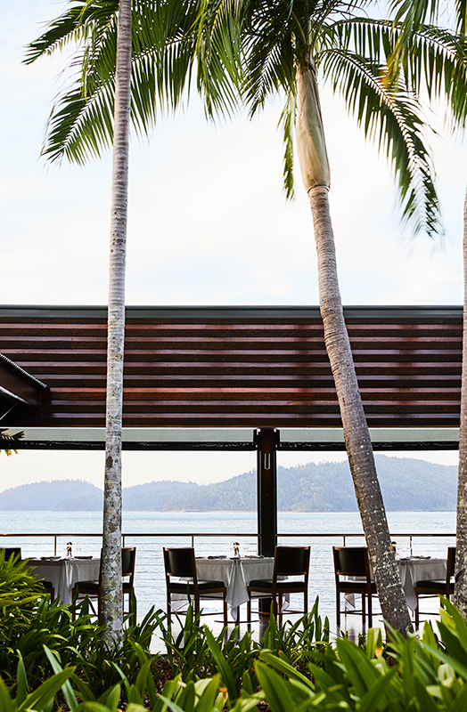exterior view of qualia resort and surrounding trees from the calm waters of the Whitsundays 