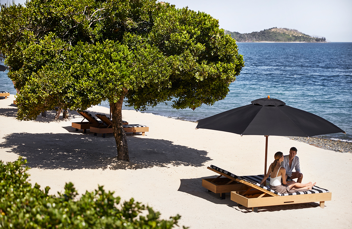 exterior view of qualia resort and surrounding trees from the calm waters of the Whitsundays 
