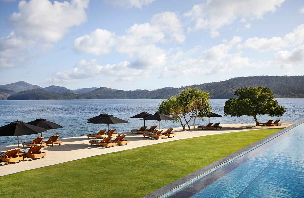 exterior view of qualia resort and surrounding trees from the calm waters of the Whitsundays 