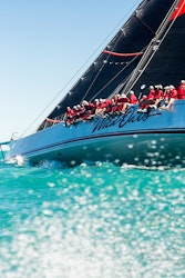 Sailing fleet passage in the turquoise waters of the Whitsundays at Hamilton Island Race Week 