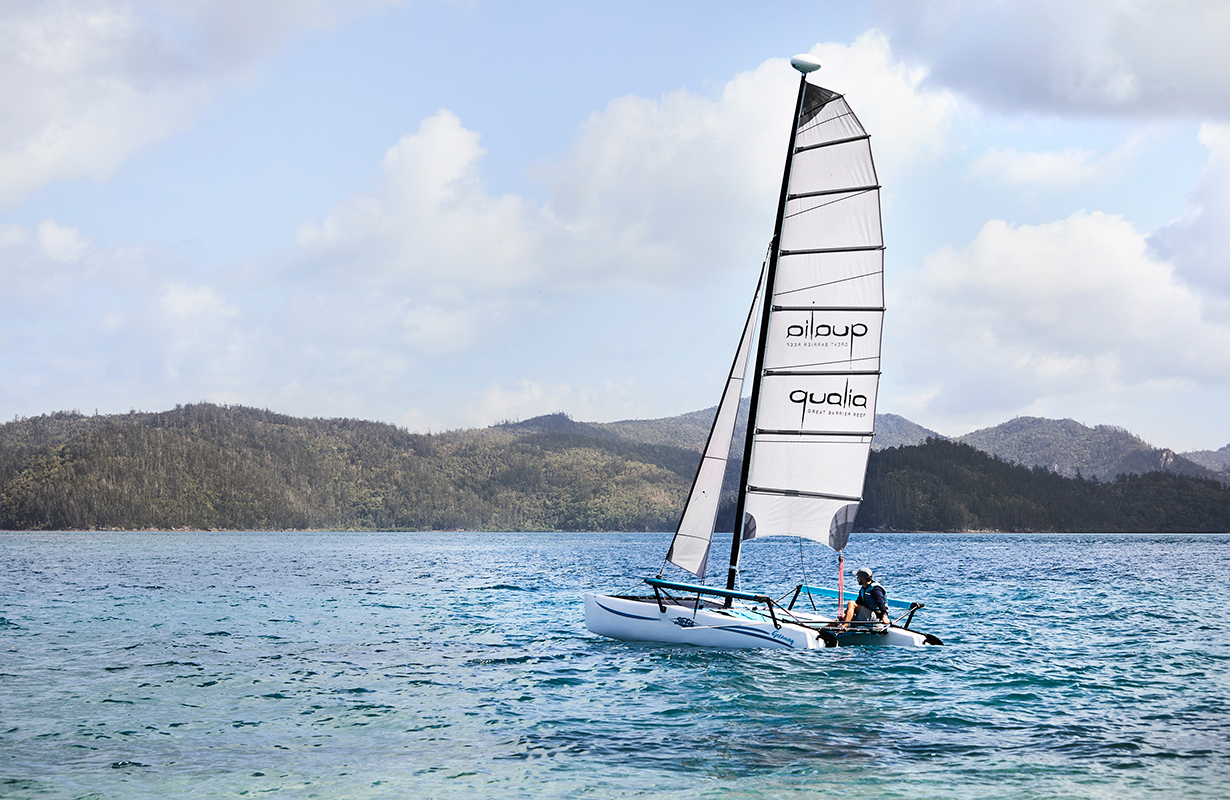 exterior view of qualia resort and surrounding trees from the calm waters of the Whitsundays 