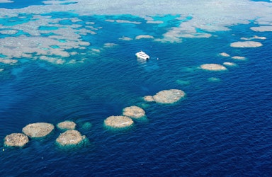 Aerial view of snorkelling and diving boat in Great Barrier Reef as part of qualia resort experience