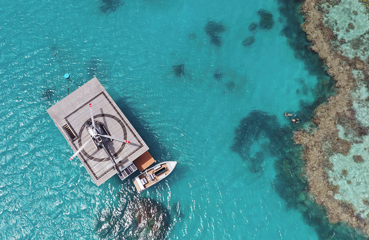 Aerial wide view of pontoon and jet ski during the qualia experience of Journey to the Heart 
