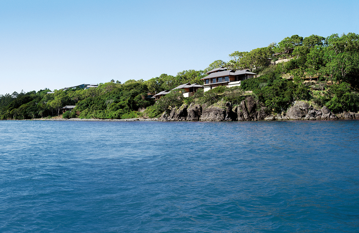 exterior view of qualia resort and surrounding trees from the calm waters of the Whitsundays 