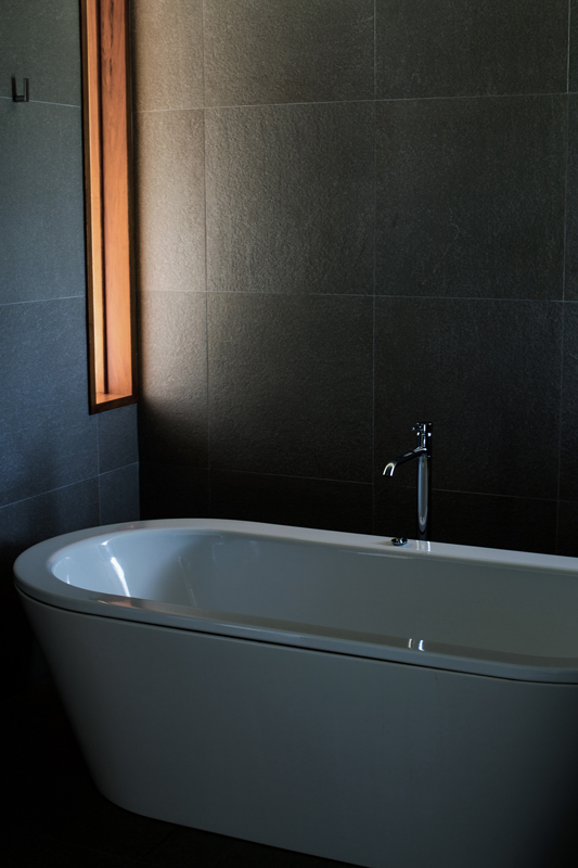 Leeward Pavilion lounge open doors towards private terrace with view of trees and the Whitsundays