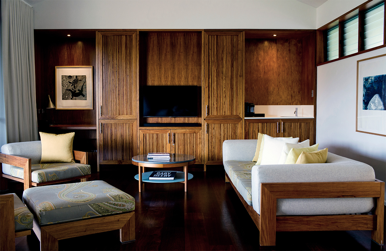 Leeward Pavilion lounge open doors towards private terrace with view of trees and the Whitsundays