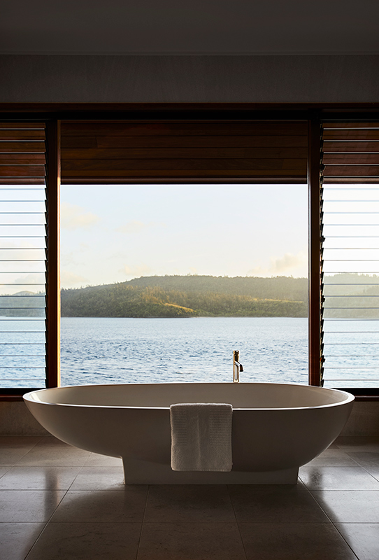 exterior view of qualia resort and surrounding trees from the calm waters of the Whitsundays 