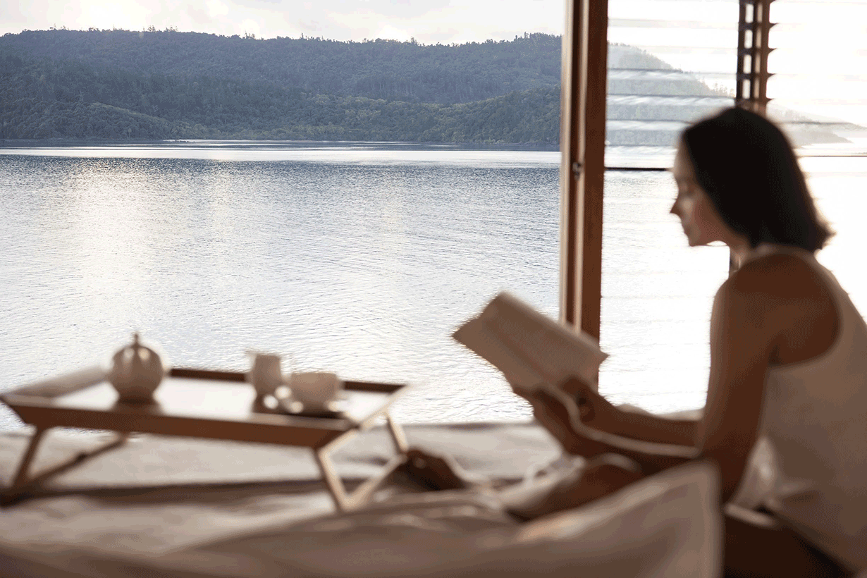 View of private deck with plunge pool and the Whitsundays from inside Windward Pavilion lounge