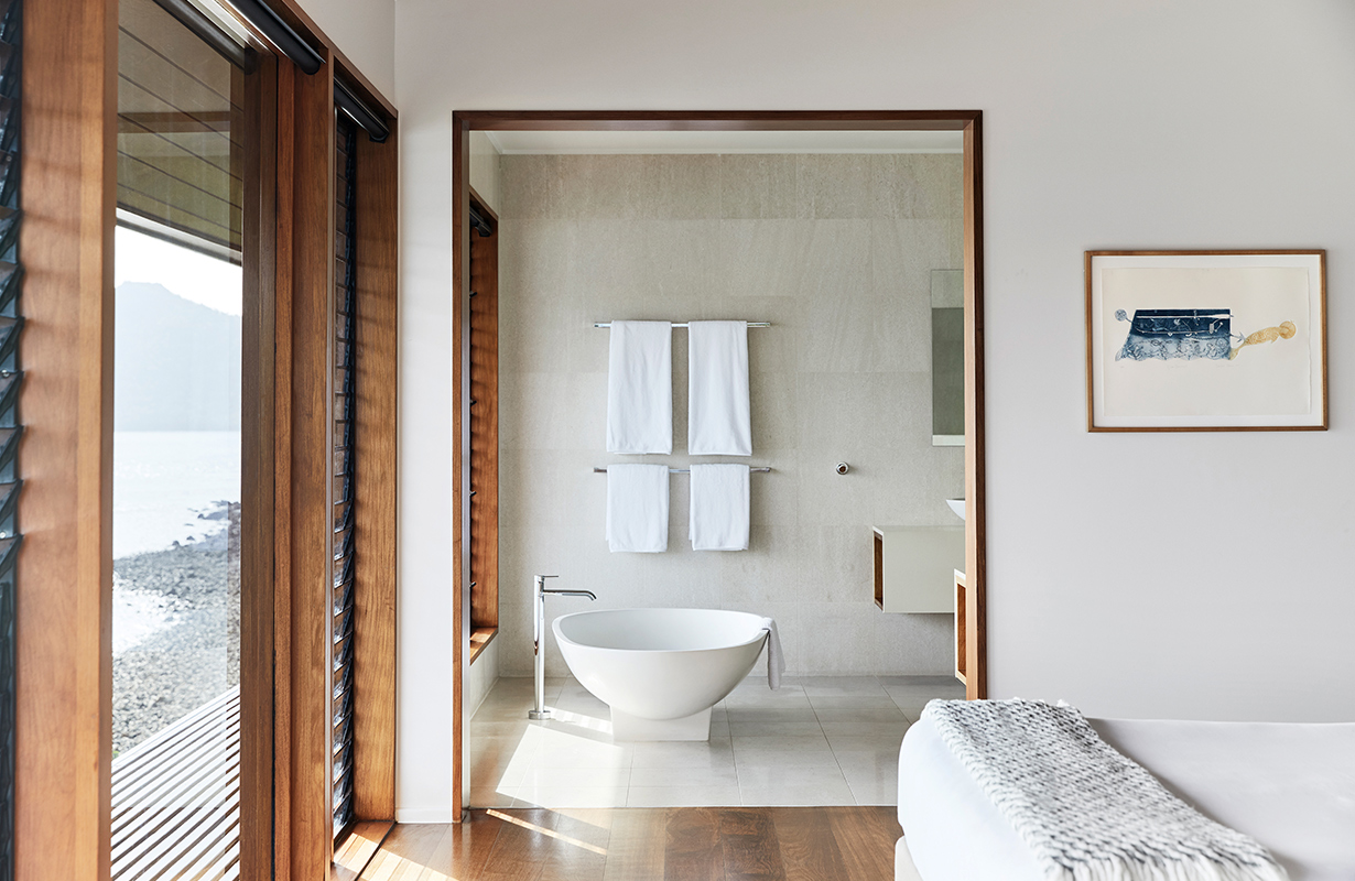 View of private deck with plunge pool and the Whitsundays from inside Windward Pavilion lounge