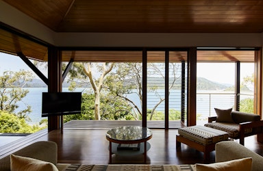 View of private deck with plunge pool and the Whitsundays from inside Windward Pavilion lounge