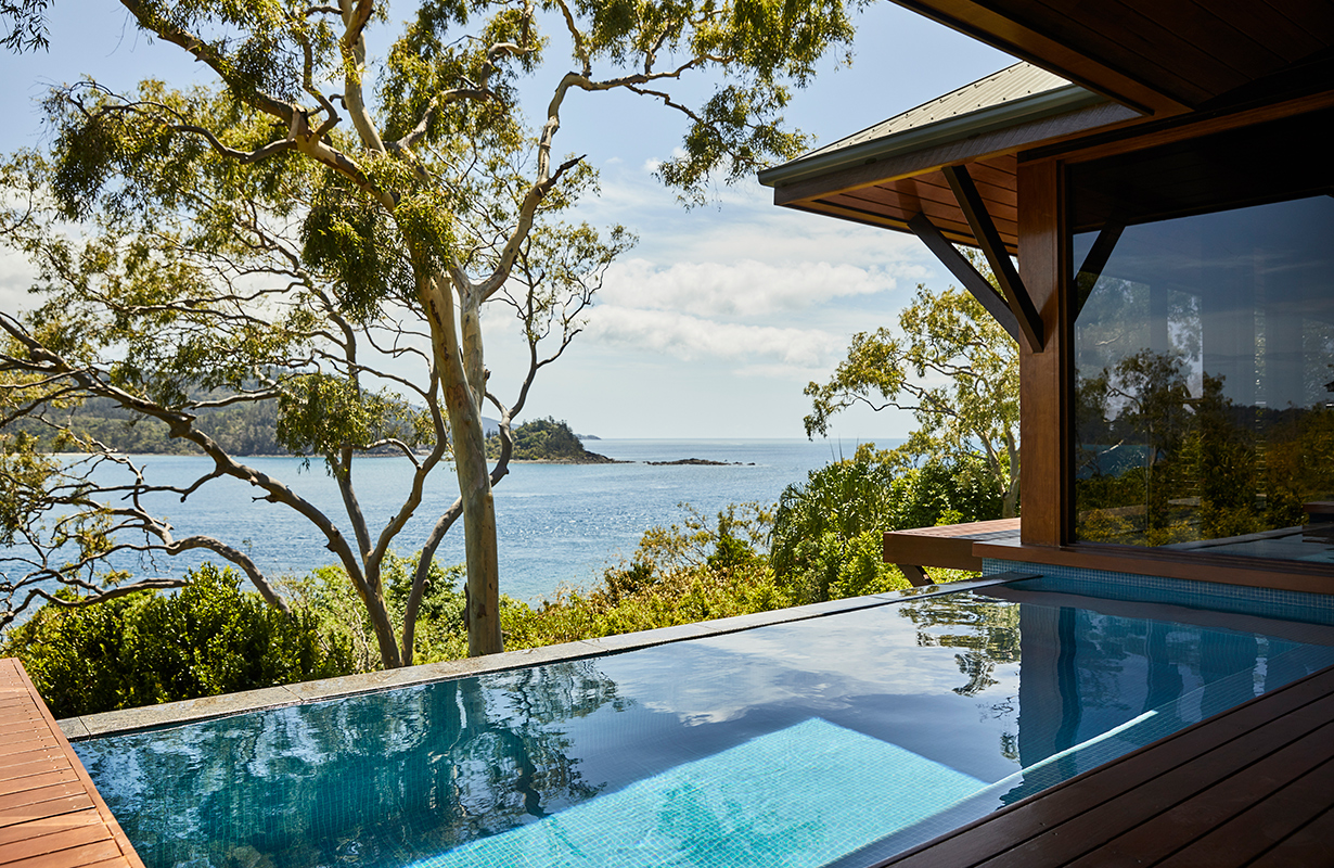 View of private deck with plunge pool and the Whitsundays from inside Windward Pavilion lounge