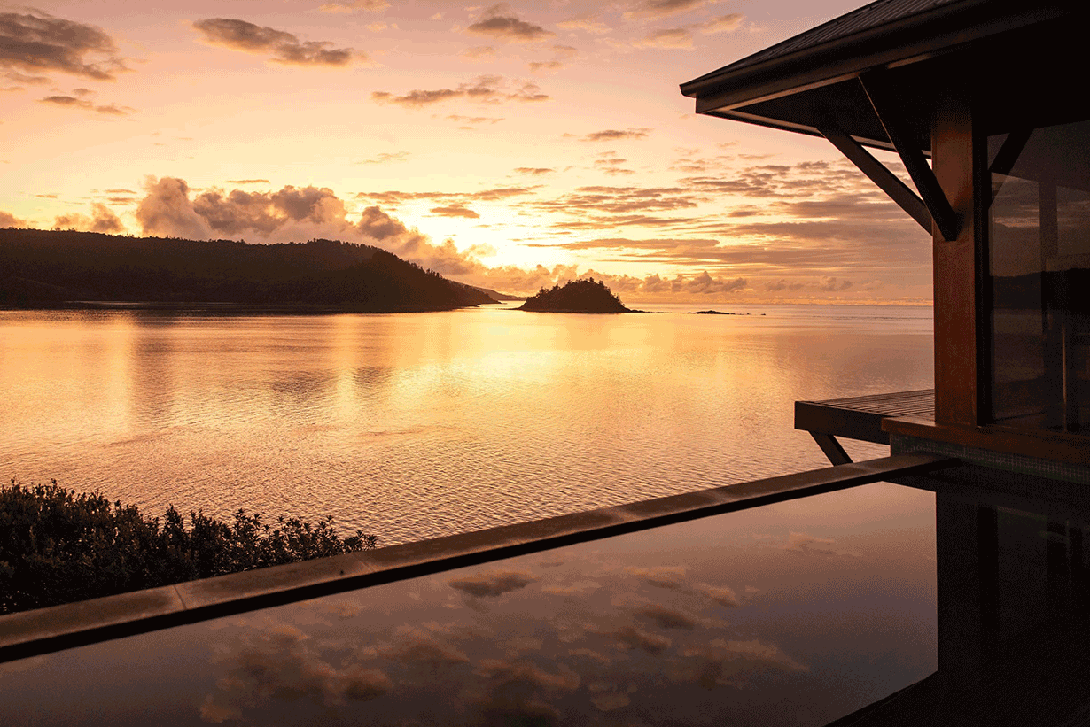 View of private deck with plunge pool and the Whitsundays from inside Windward Pavilion lounge