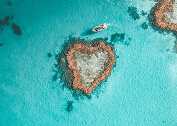 Aerial view of Heart Island in Heart Reef and a boat in the Great Barrier Reef