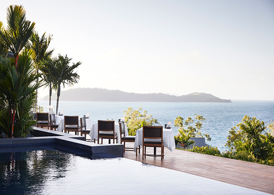 Whitsunday sunset view from dinner tables set outdoor at qualia resort's Long Pavilion restaurant