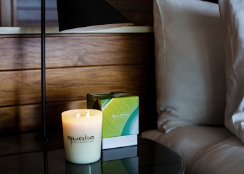 Candle and candle box with 'qualia' inprint on side table at qualia resort 