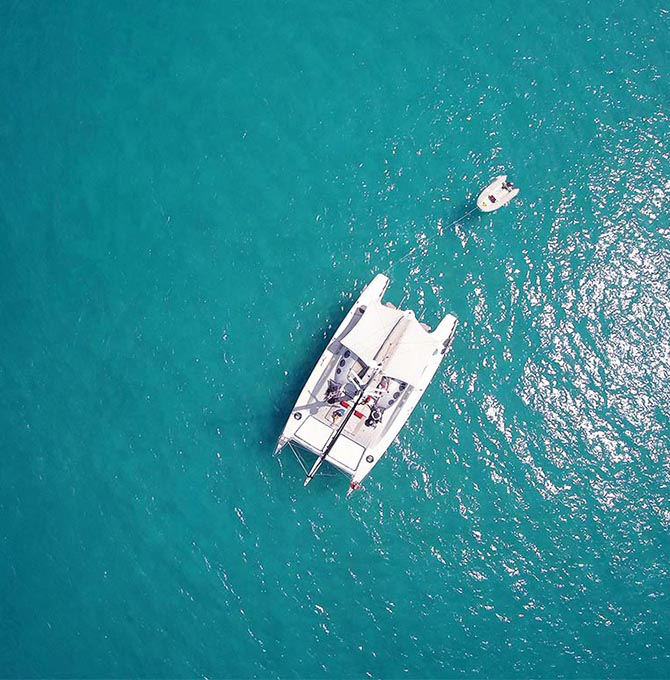 Aerial view of Ricochet luxury catamaran with floating boat attached as part of qualia luxury experience