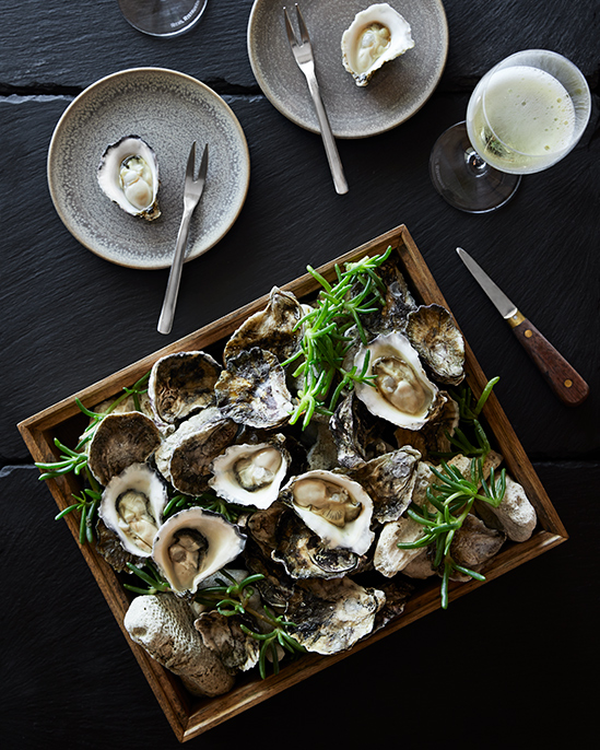 Platter of oysters and glass of champage as part of Talk and Taste experience at qualia resort's Long Pavilion