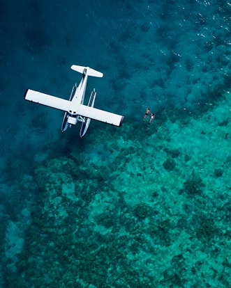 Aerial of luxury sea plane landed on Great Barrier Reef waters as part of qualia scenic flight experience