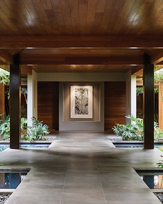 Spa qualia entrance gardens with two pillars and centered mounted wall painting 