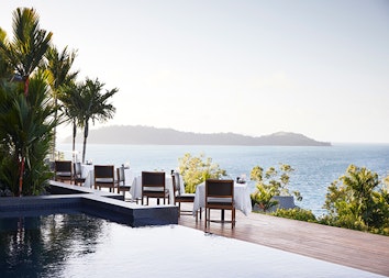 Whitsunday view from dinner tables set outdoor at qualia resort's Long Pavilion restaurant