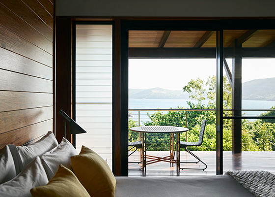 View from Leeward Pavilion bedroom of private furnished deck and ocean view of Whitsundays