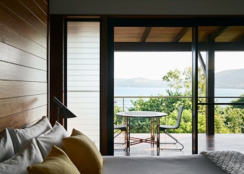 View from Leeward Pavilion bedroom of private furnished deck and ocean view of Whitsundays