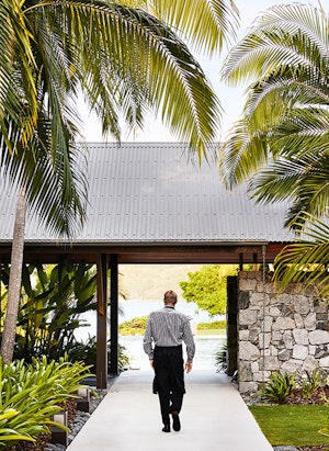 qualia resort Pebble Beach restaurant waiter walking through garden path in the Whitsundays