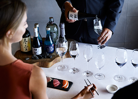 Qualia Resort Talk and Taste Experience with man and woman enjoying sushi and sake tasting