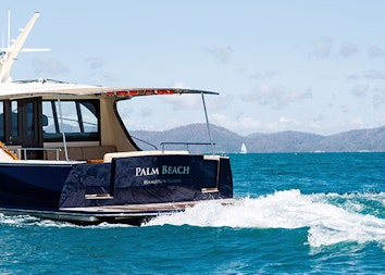 qualia resort experience of luxury motor boat named Palm Beach making waves in the Whitsundays water