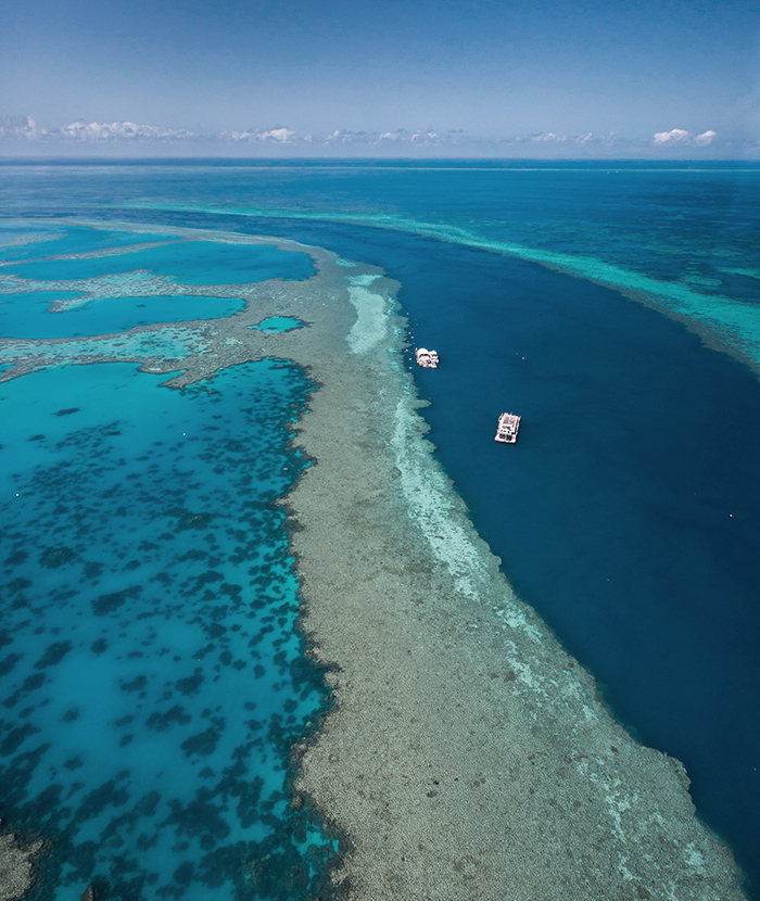 Aerial view of boats in the Great Barrier Reef as part of qualia Scenic Flight experience
