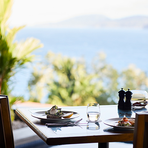 qualia Long Pavilion breakfast table with poached eggs and salad with Whitsundays views