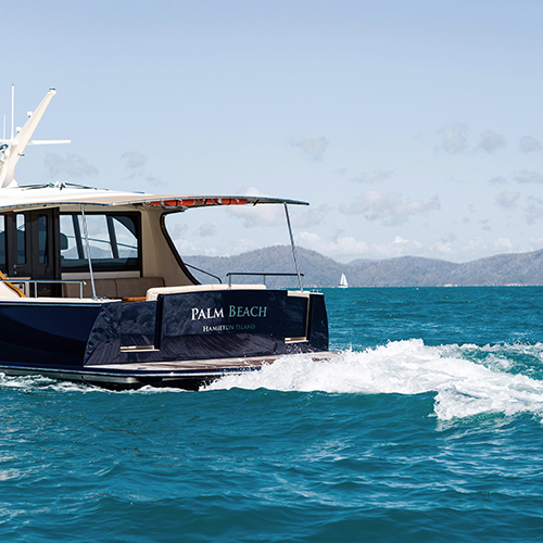 qualia resort experience of luxury motor boat named Palm Beach making waves in the Whitsundays water