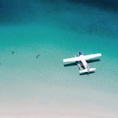 Aerial view of a seaplane in the turquoise waters of Whitehaven Beach