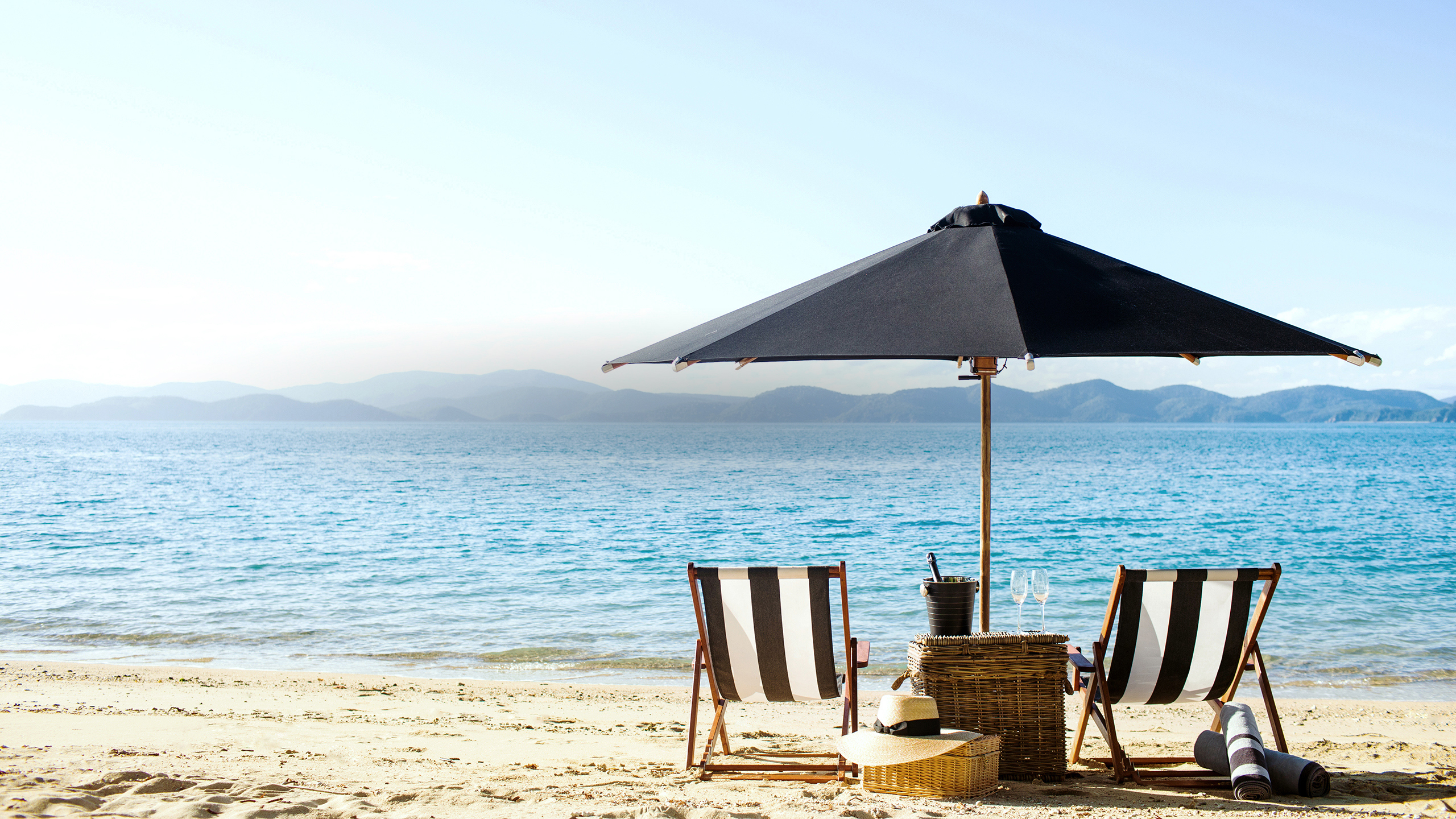 qualia Resort Luxury Beach Drop Off Experience with Two Sun Chairs and Umbrella on the Beach