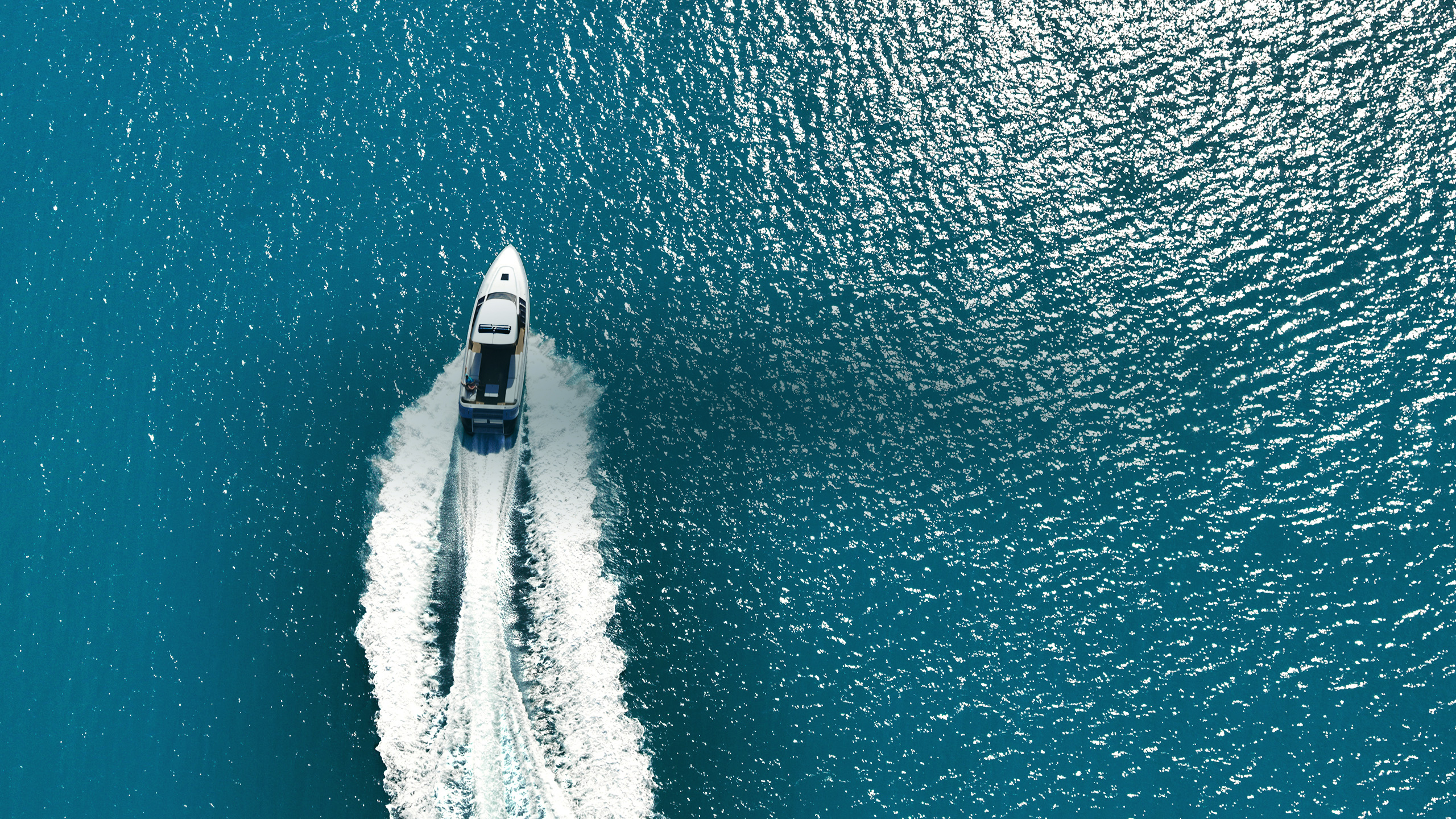 qualia Resort luxury experience activity with aerial view of boat charter and glittering sea