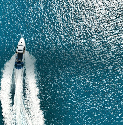 qualia Resort luxury experience activity with aerial view of boat charter and glittering sea
