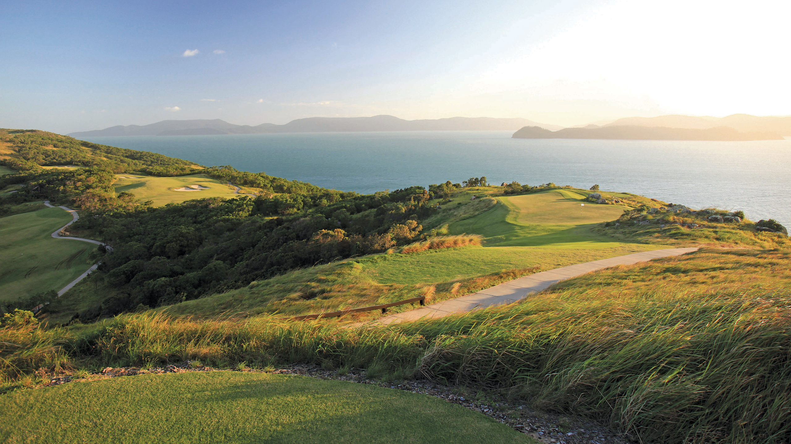qualia View across Hamilton Island Golf Course with sunlight pouring across from neighbouring Whitsunday island